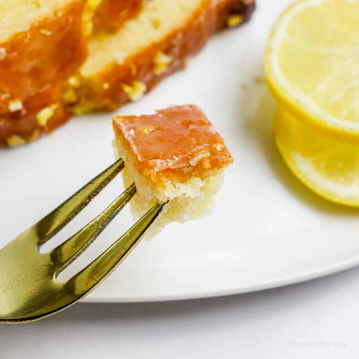 a piece of lemon bread on a golden fork