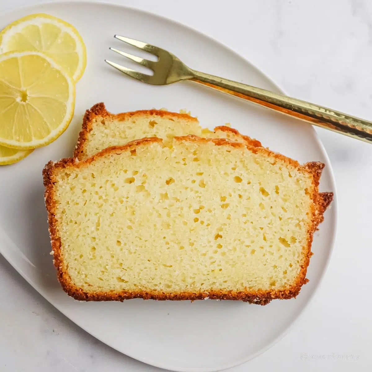 overhead shot of slices of grain-free vegan lemon bread on a white plate
