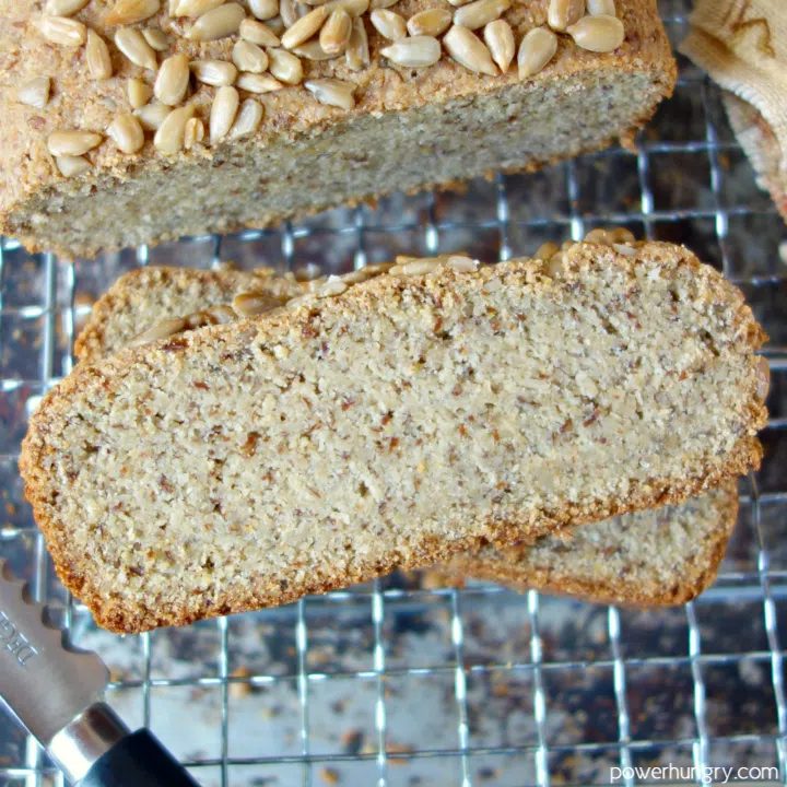 two slices of sunflower seed bread on a wire rack