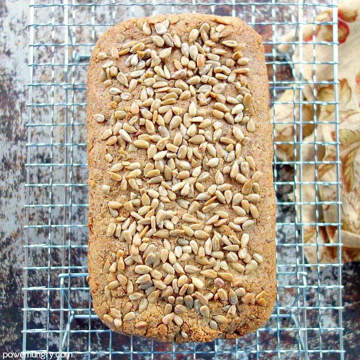overhead shot of vegan keto sunflower seed bread on a silver metal cooling rack