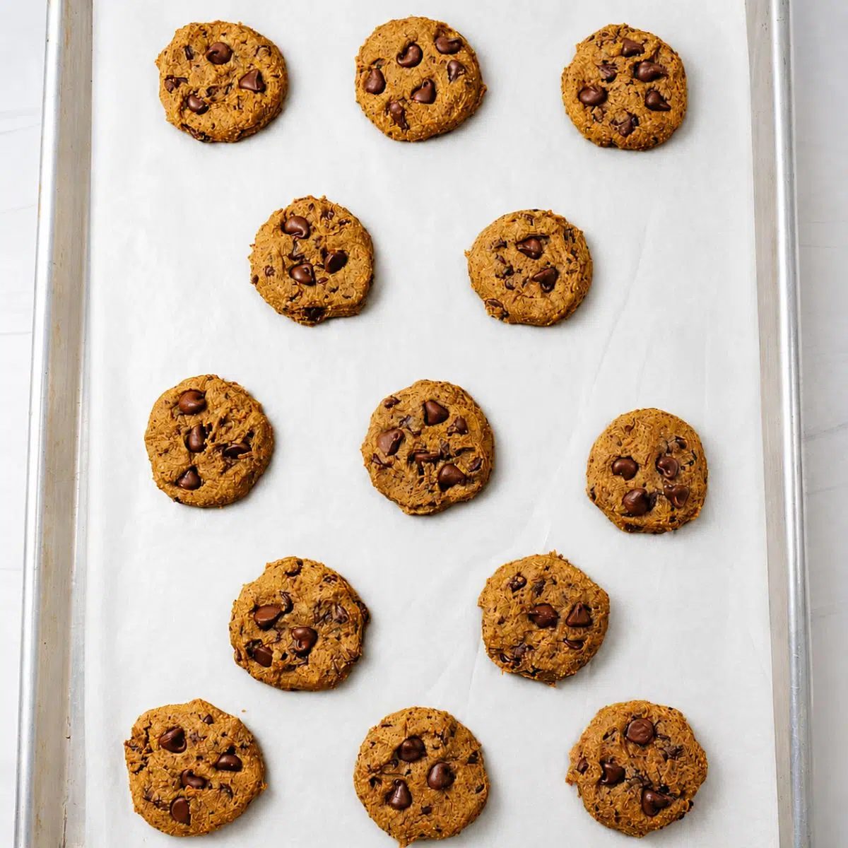 baked vegan lentil chocolate chip cookies on a baking sheet