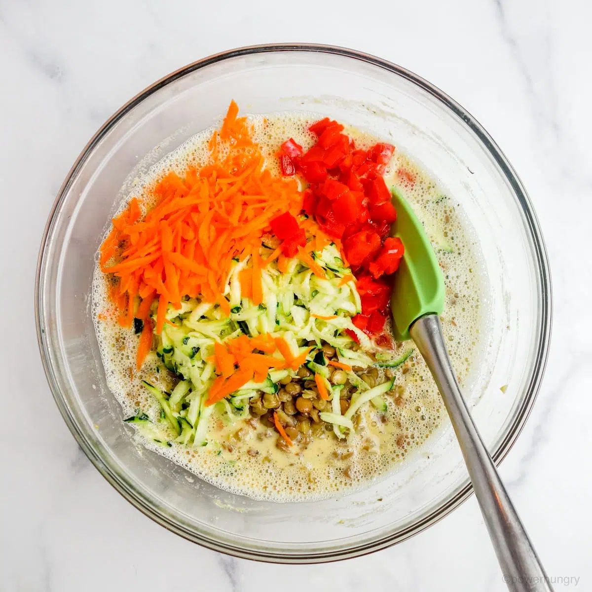 bowl filled with the batter and fillings for vegan lentil frittata bars