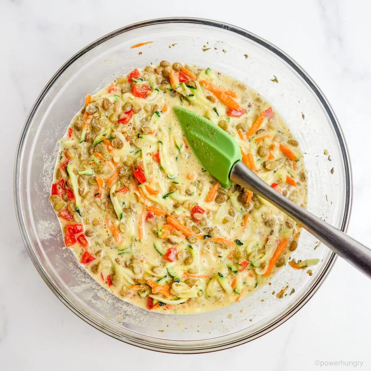 bowl filled with the batter and fillings for vegan lentil frittata bars