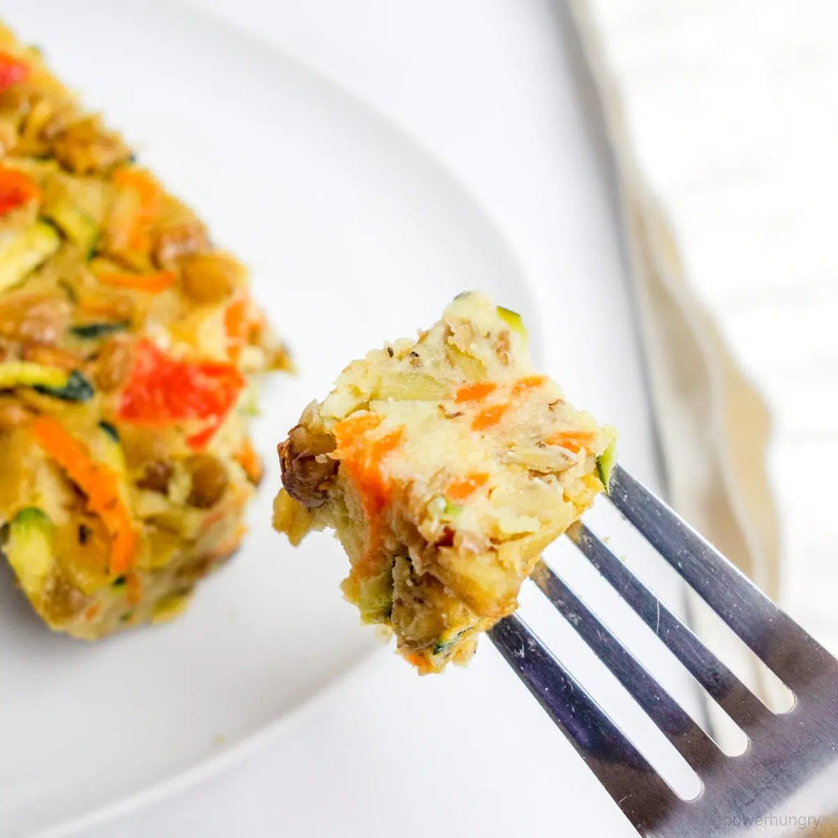 close up of a bite of vegan lentil frittata bars