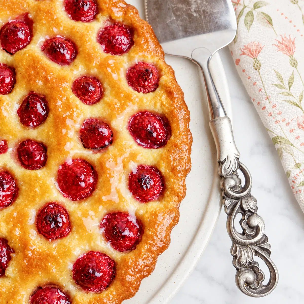 close-up of crustless frangipane tart with raspberries