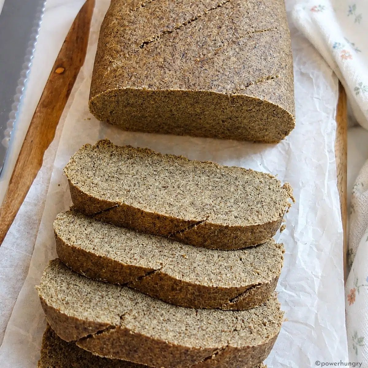 sliced vegan oat fiber bread on a wood cutting board