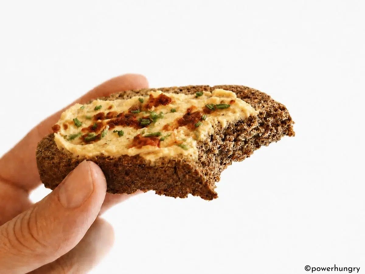 a slice of vegan oat fiber bread with a bite taken out