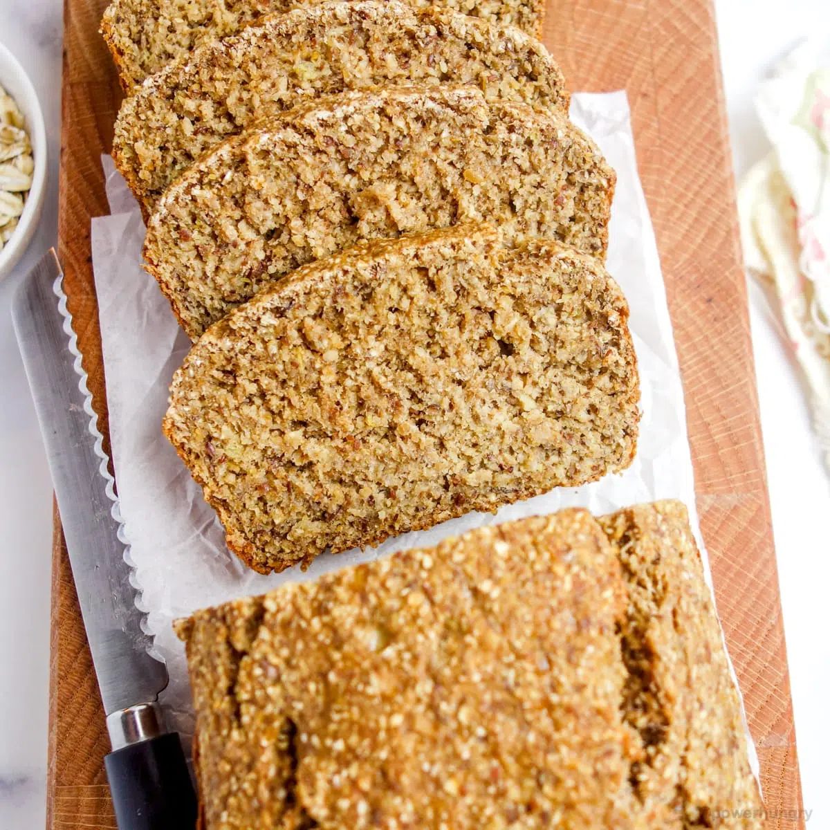 overhead view of oat flour loaf on a wooden cutting board