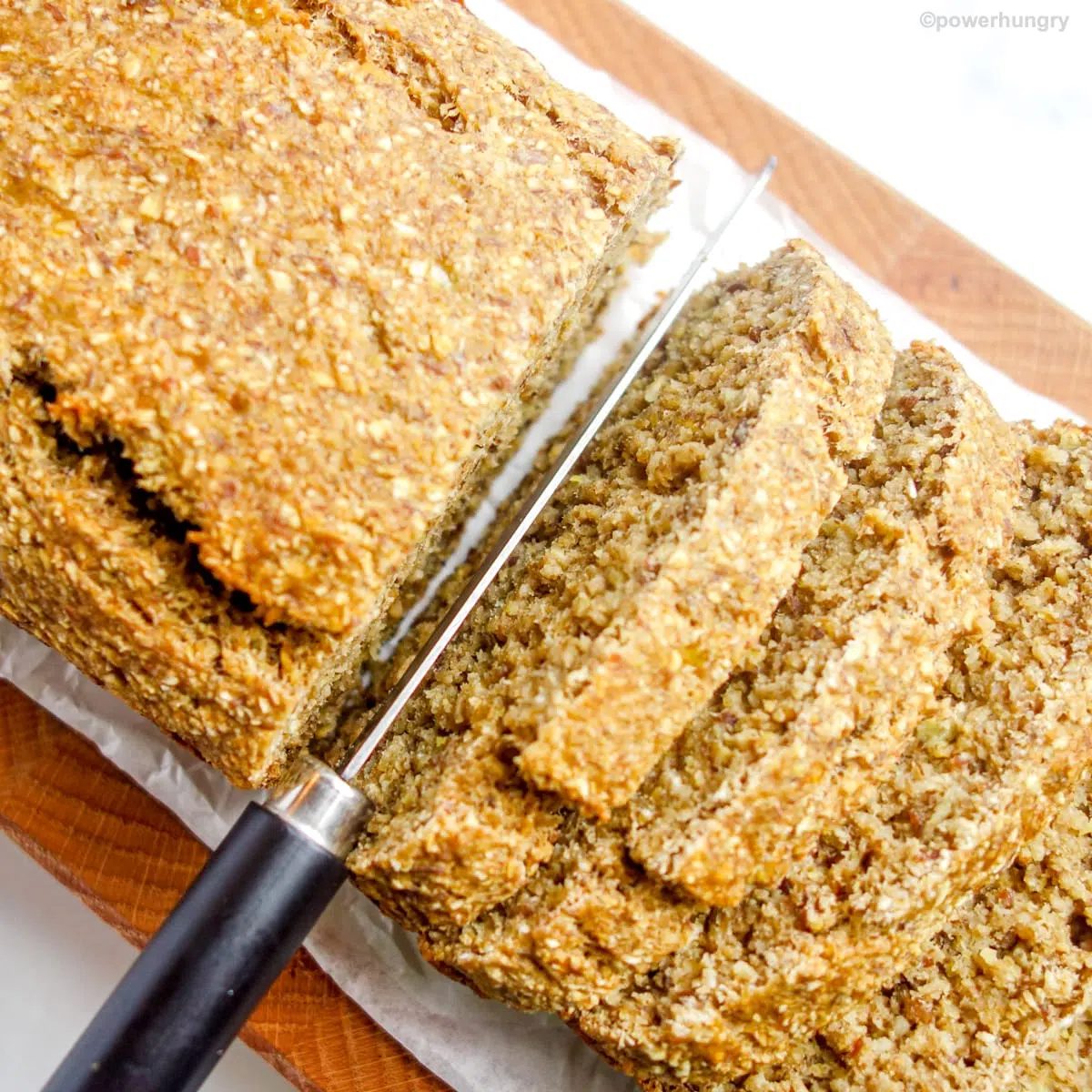 overhead shot of vegan oat flour banana bread cut into thick slices