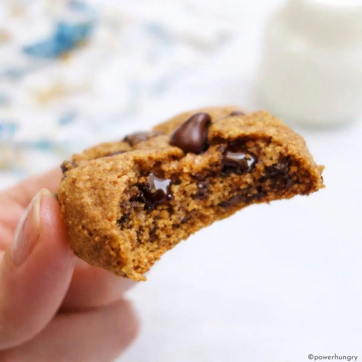 single chocolate chip cookie with a bite showing interior