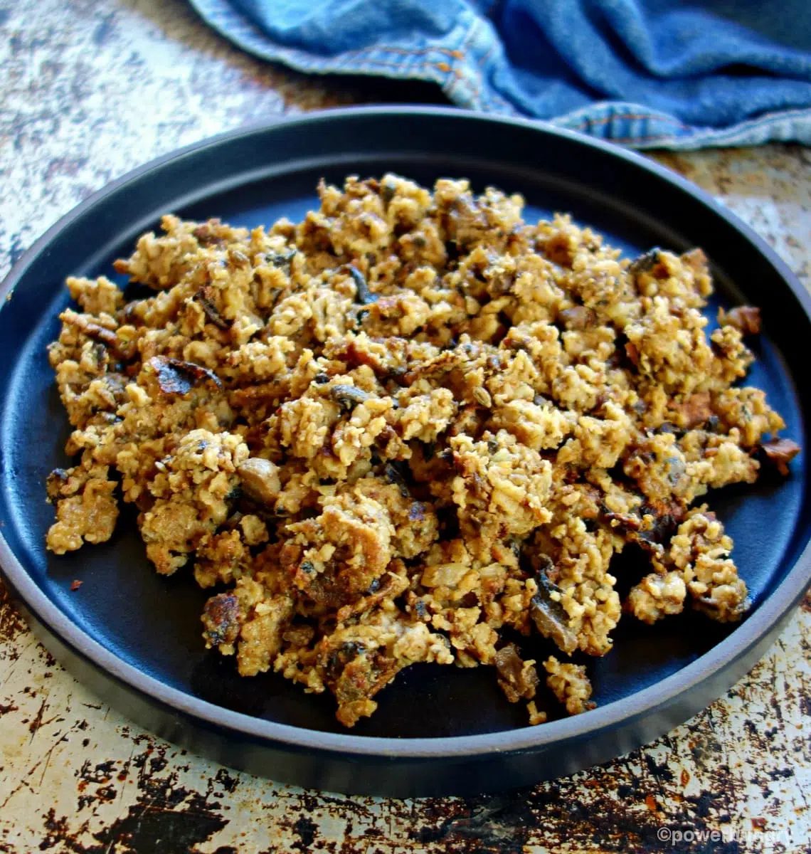 browned mushroom oat ground beef on a black plate