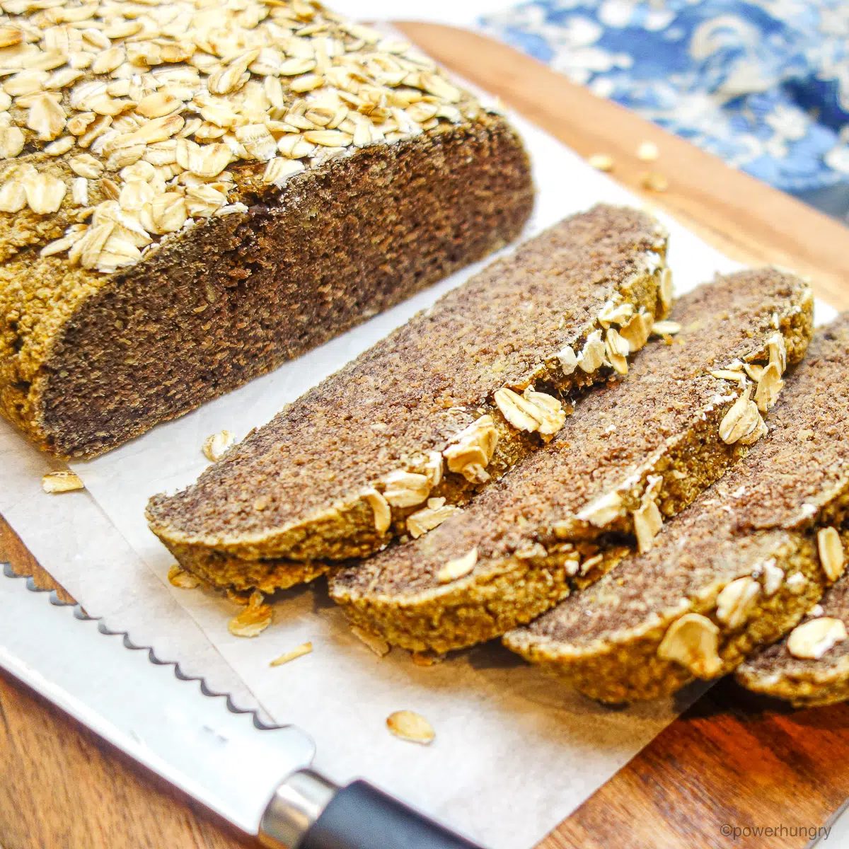slices of oat protein brea on a cutting board with a blue napkin alongside