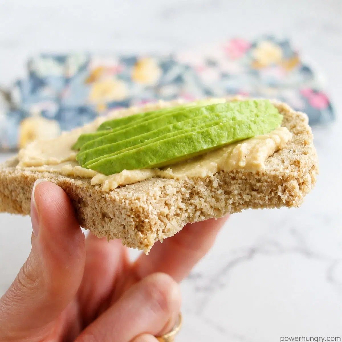 oat sandwich bread topped with humus and slied avocado