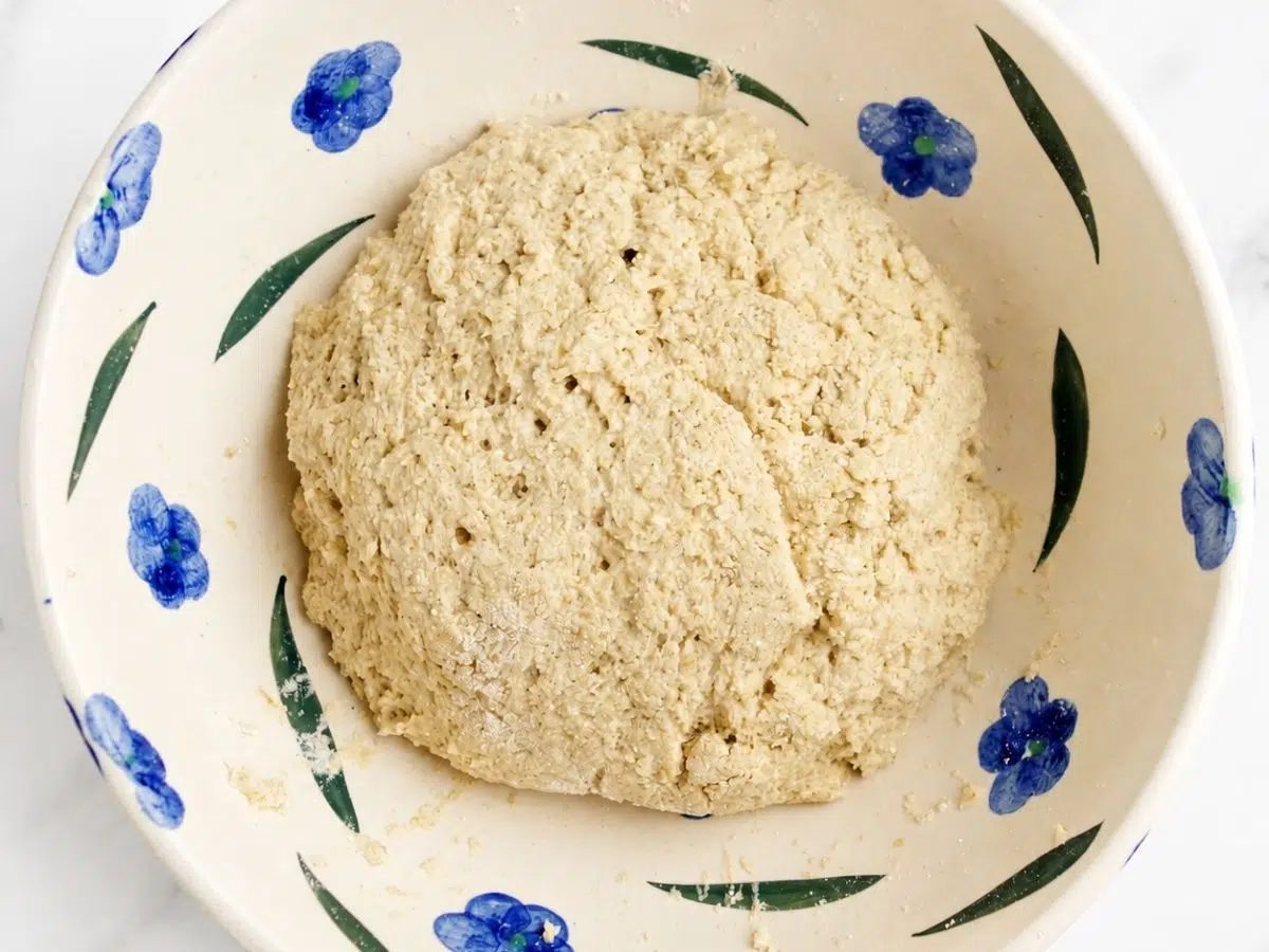 dough for vegan gluten-free oat bread, in a blue and white bowl