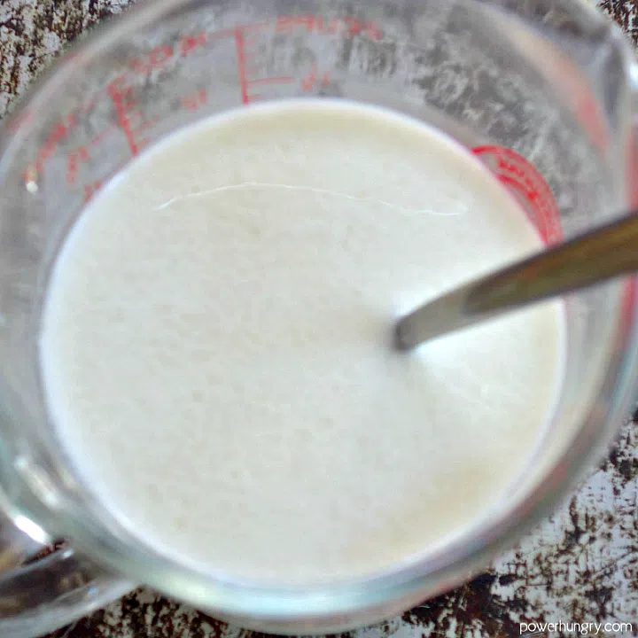glass measuring cup filled with nondairy buttermilk