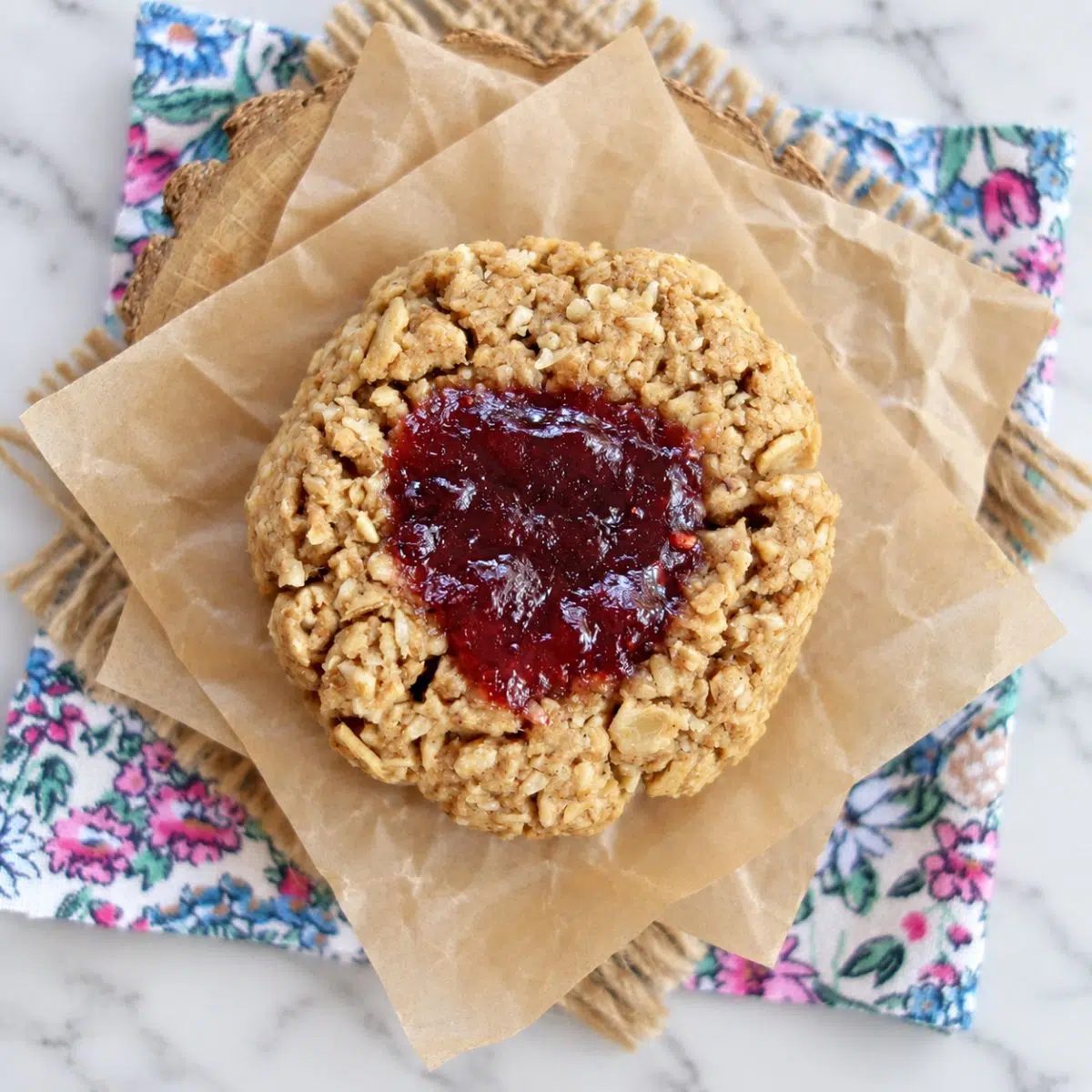 a single vegan oat flour cookie filled with jam