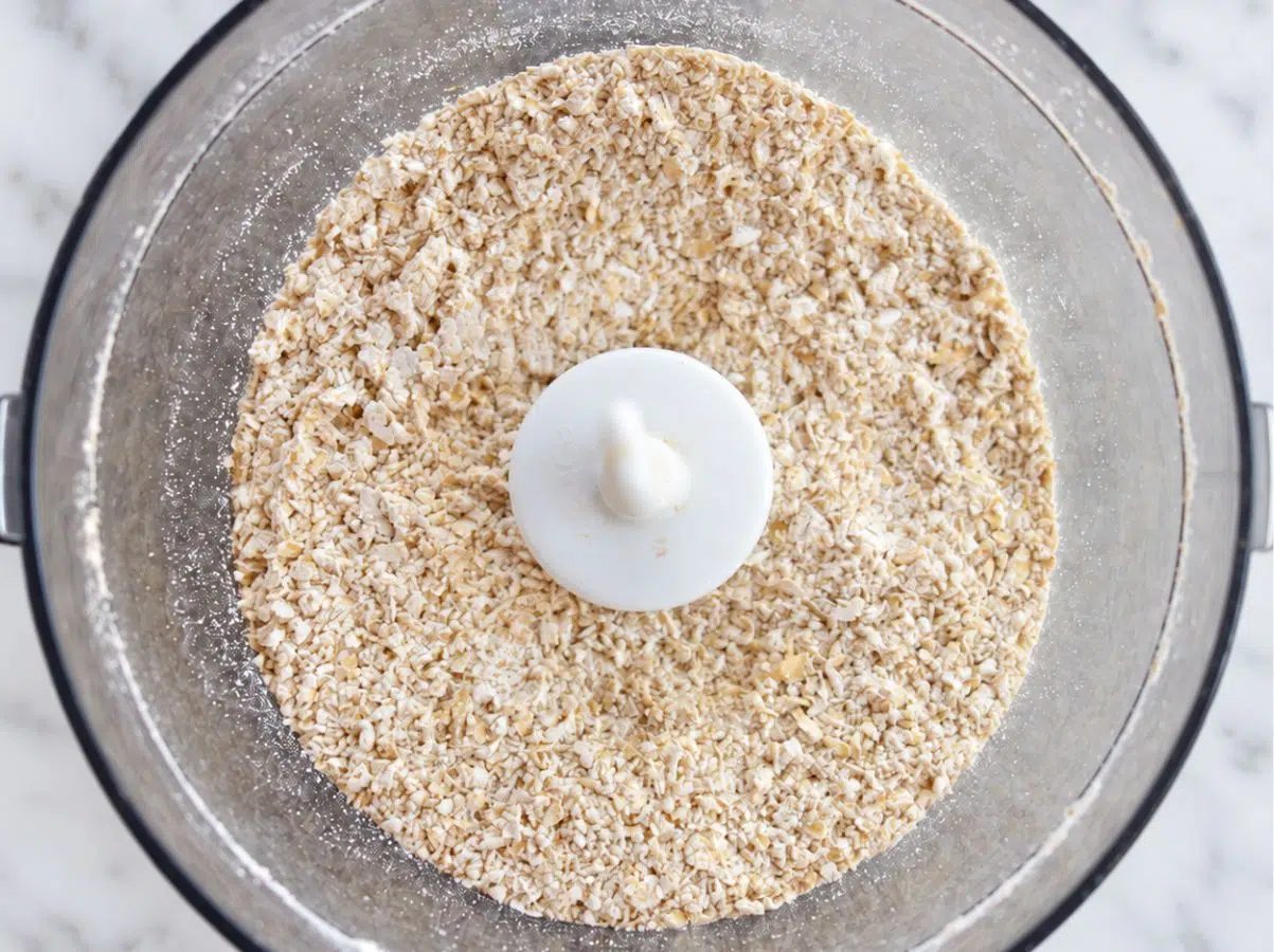 rolled oats getting ground into oat flour in a food processor