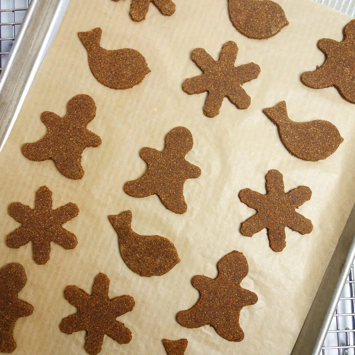 cookie shapes on a parchment lined baking sheet