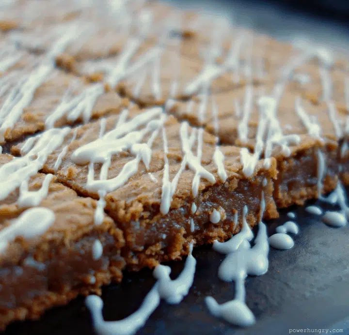 close up of gingerbread chickpea blondies on a slate cutting board