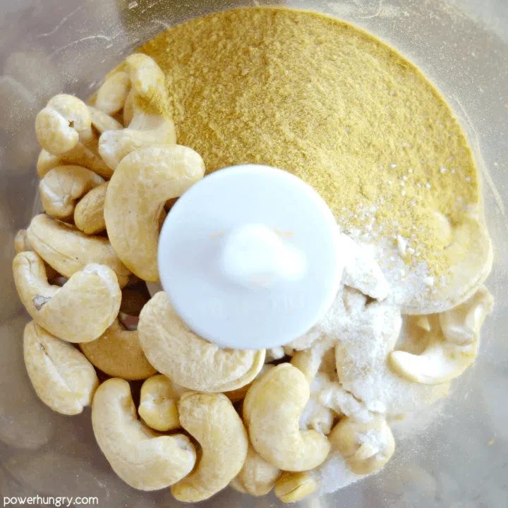 ingredients for vegan parmesan cheese in a food processor bowl
