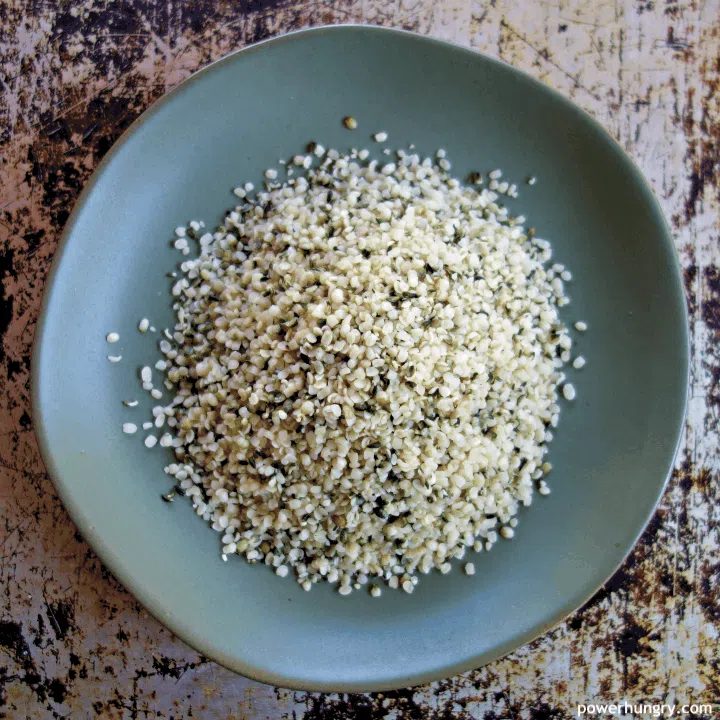 close-up of hemp hearts on a sage green plate