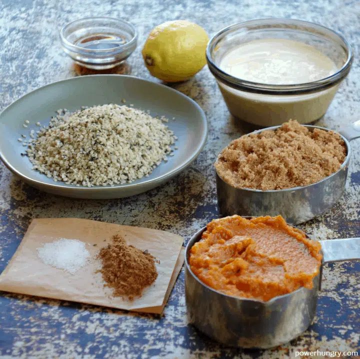 ingredient for vegan pumpkin hemp heart cheesecake laid out on a metal tray