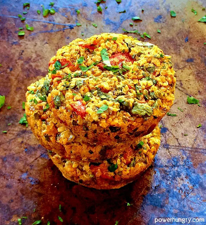 Baked vegan quinoa mini burgers (made in a muffin tin) stacked 3 high on a baking sheet