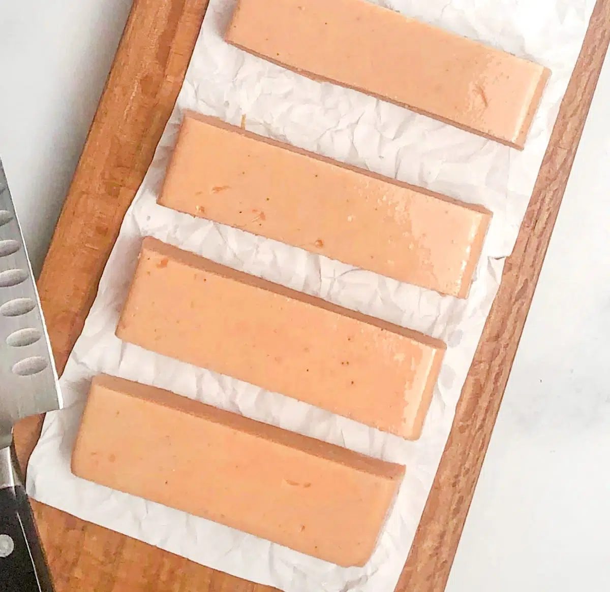 cut pieces of vegan salmon on a wooden cutting board