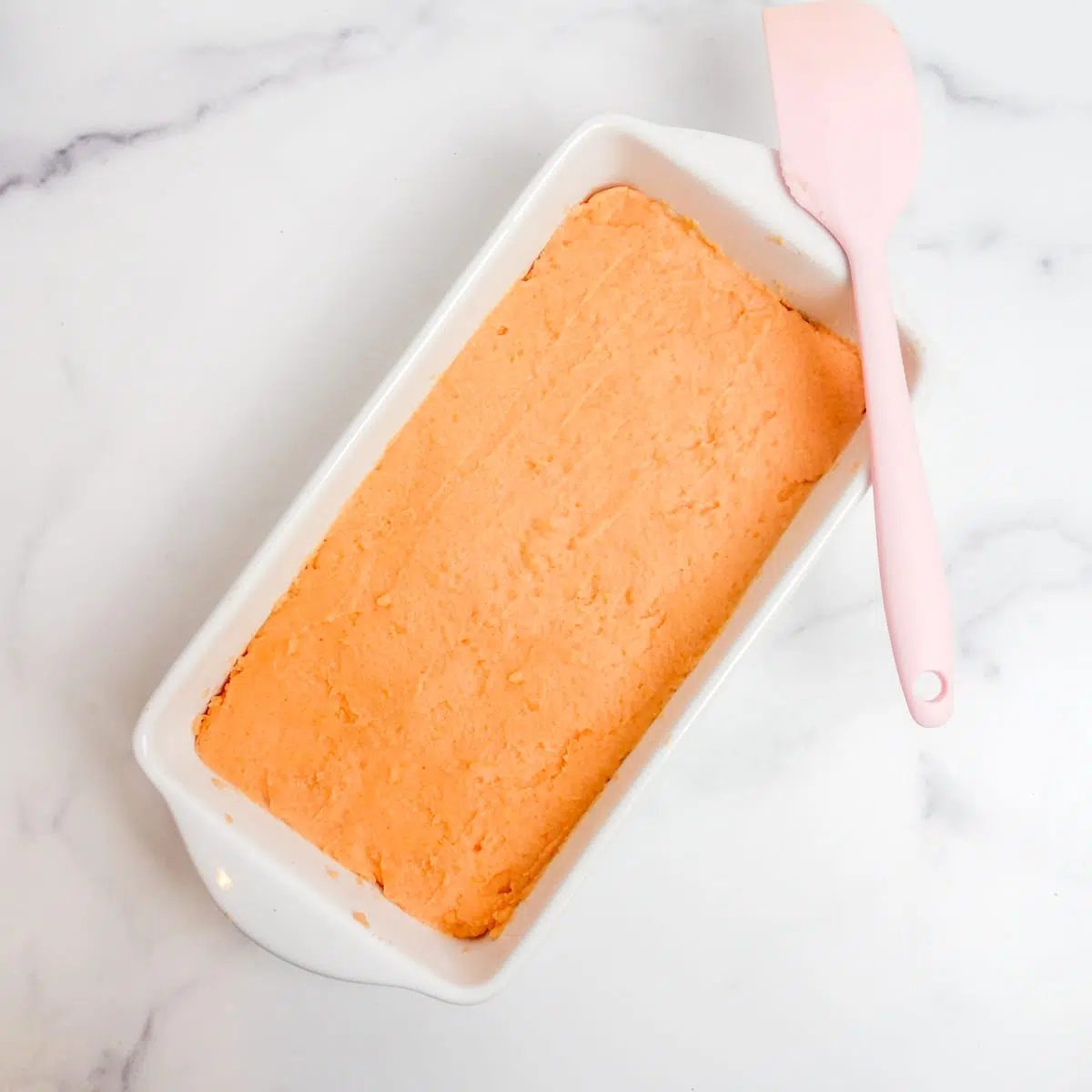 carrot lentil mixture in a white loaf pan