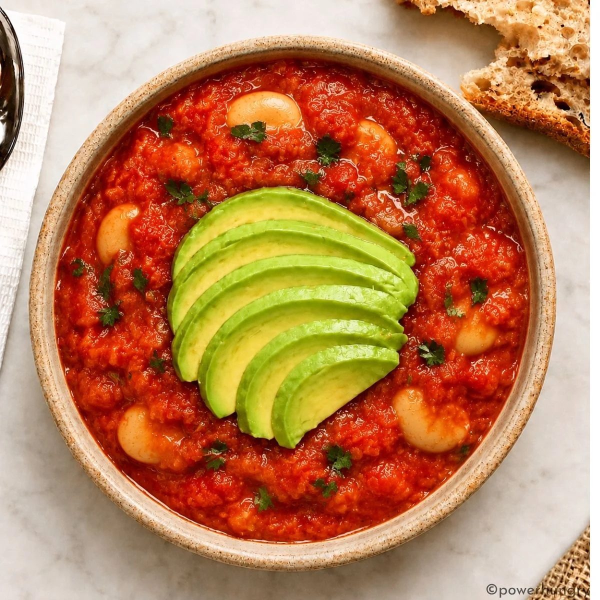 bowl full of vegan shakshuka with butter beans and avocado