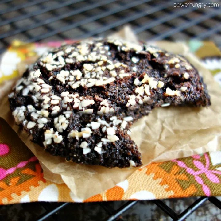 chocolate sunflower crinkle cookie, on a colorfulnapkin, with a bite taken out