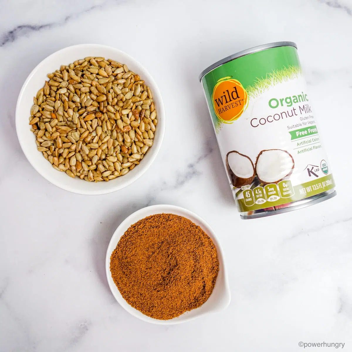 ingredients for sunflower seed ice cream on a white marble countertop