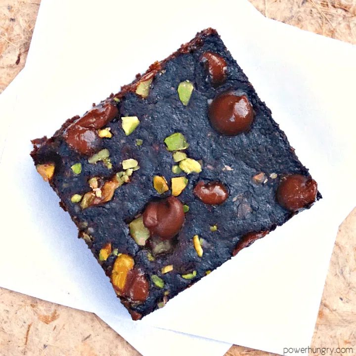 chocolate chip studded brownie on a piece of parchment paper