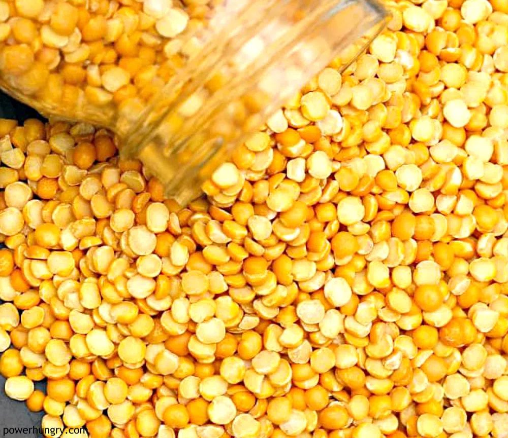 yellow split peas spilling out of a glass jar