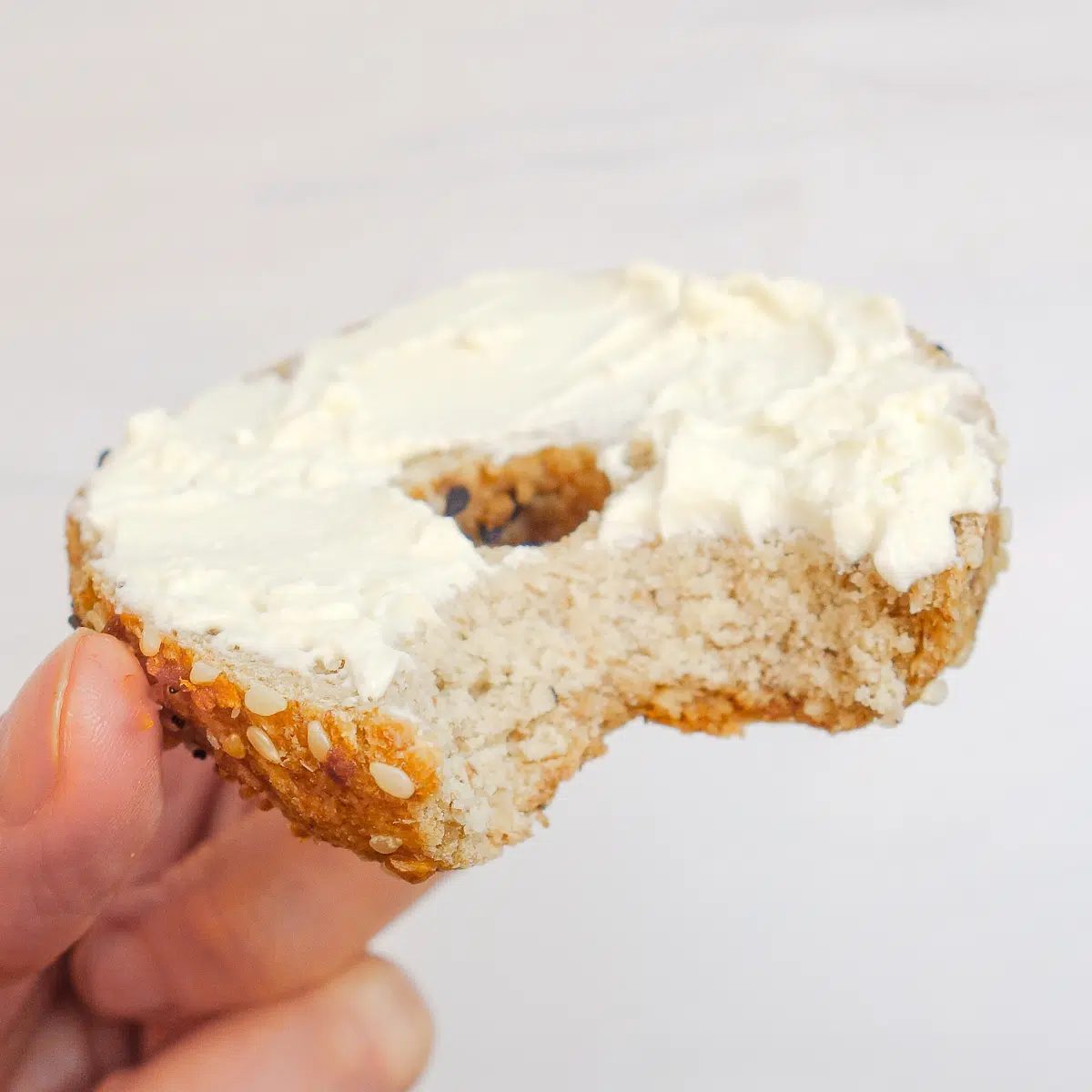 white bean bagel with a bite taken out