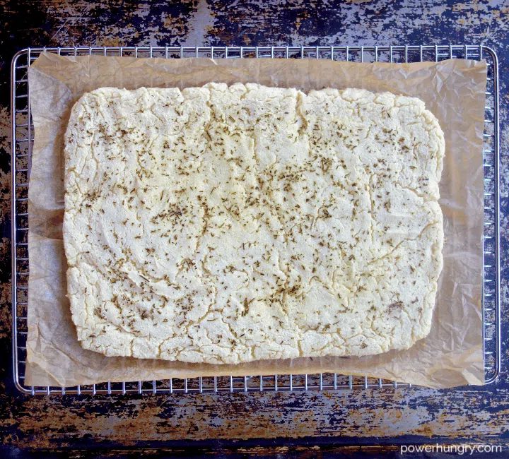 baked white bean flatbread on a silver cooling rack