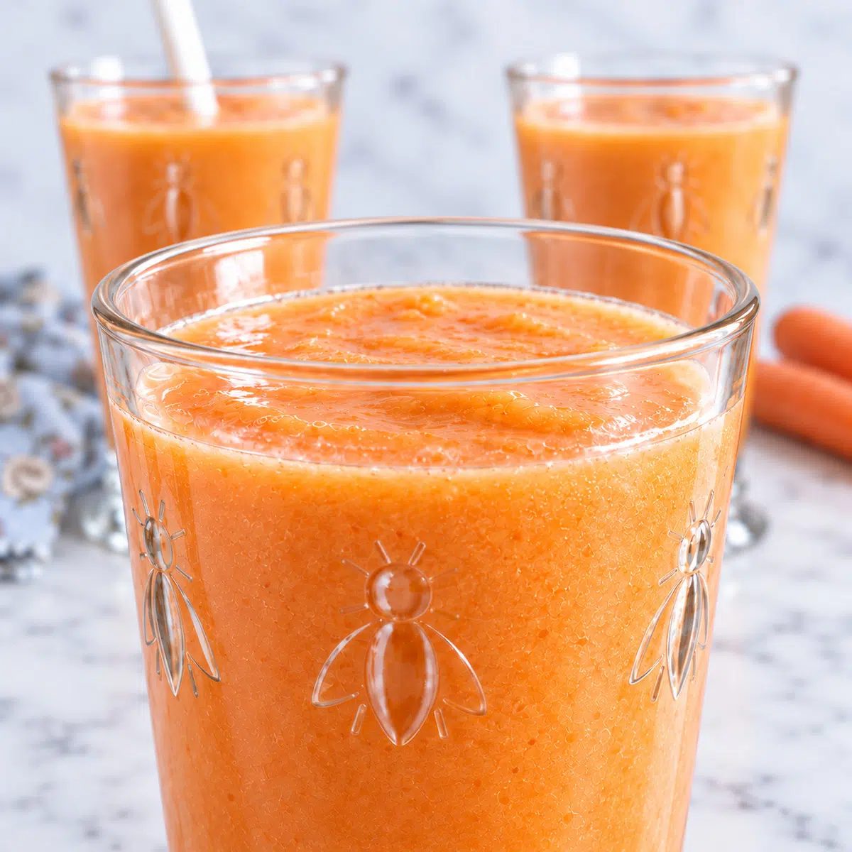 close-up of whole carrot mango smoothie