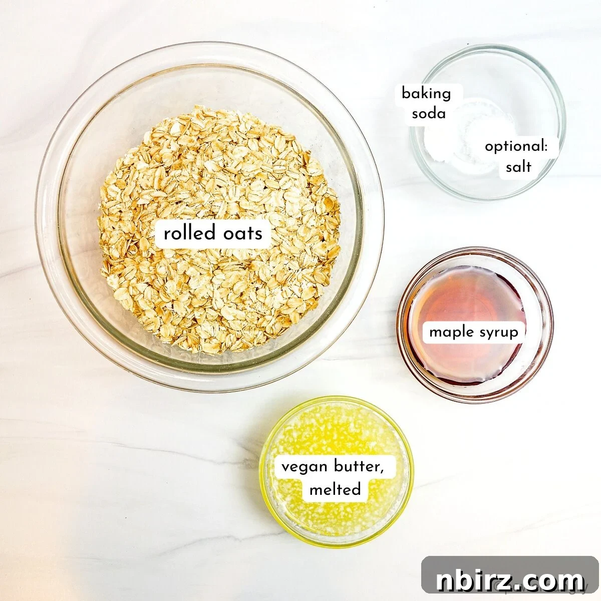 Wholesome Scottish Vegan Gluten Free Oatcakes 3 A flat lay photograph of all the simple ingredients required to make Scottish oatcakes, including oats, baking soda, maple syrup, and vegan butter