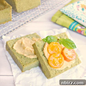 Close-up of a square piece of fresh herb lentil bread, showing its texture and green hue.