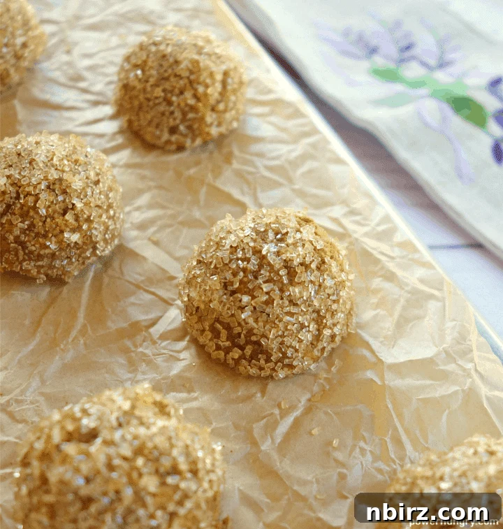 Wholesome Plant-Based Gluten-Free Pumpkin Almond Cookies 2 Pumpkin almond flour cookies arranged beautifully on parchment paper, resting on a baking sheet.