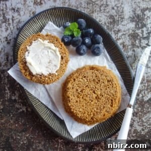 Easy vegan flax mug muffin on a metal plate, spread with dairy-free butter