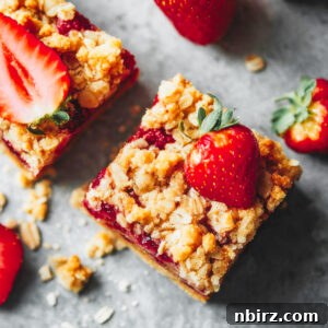 healthy strawberry oatmeal bars on a grey background