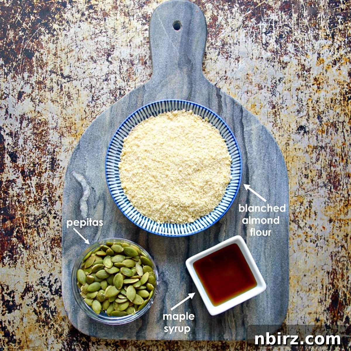 Simple Three Ingredient Vegan Grain Free Almond Flour Granola Bars 4 Ingredients for almond flour granola bars on a gray cutting board