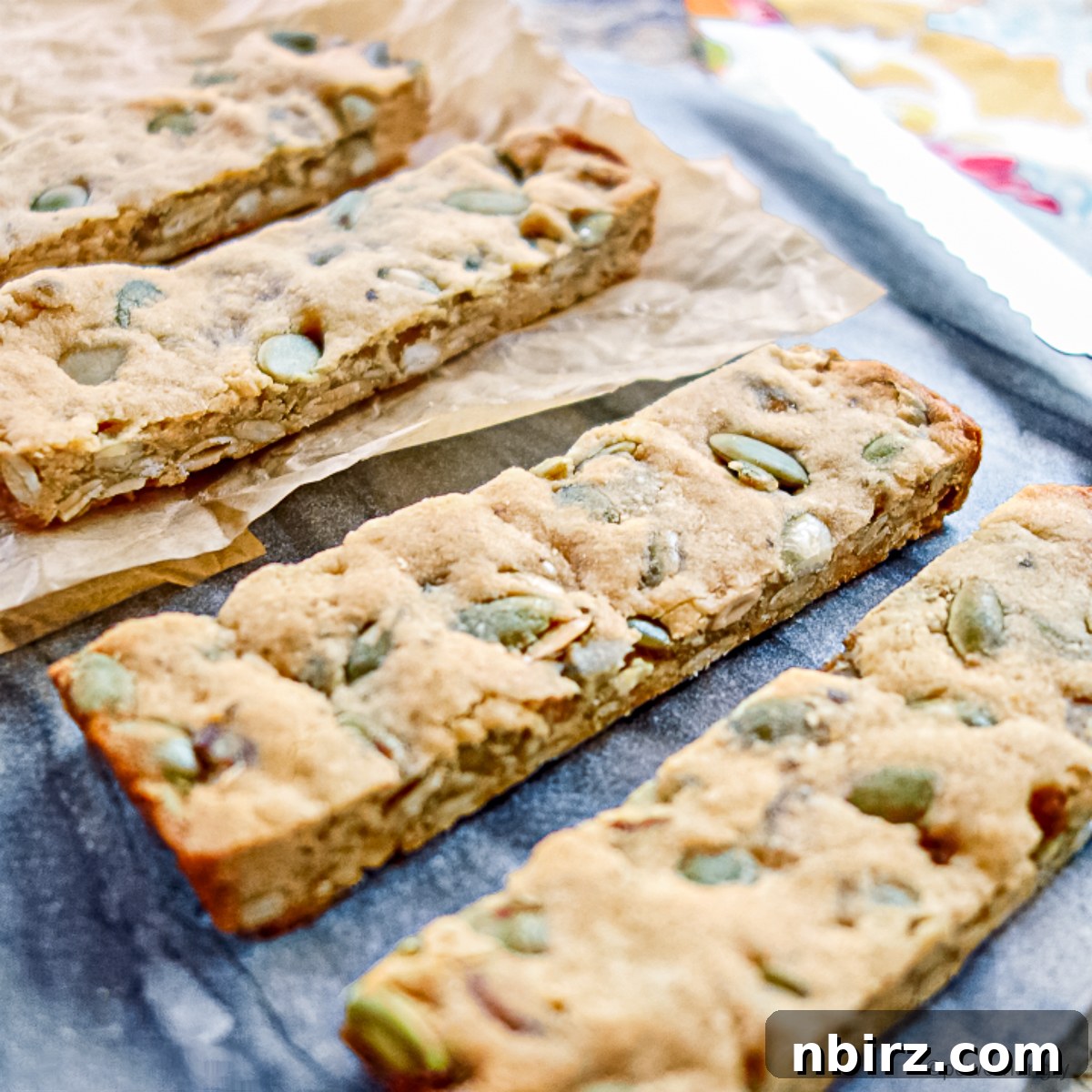 Simple Three Ingredient Vegan Grain Free Almond Flour Granola Bars 7 Freshly baked and cut granola bars on a wooden cutting board