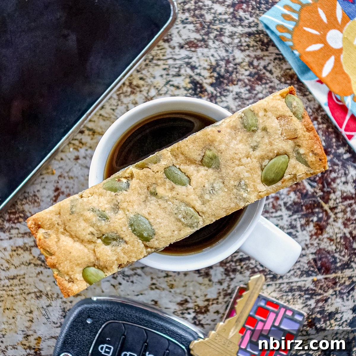 Simple Three Ingredient Vegan Grain Free Almond Flour Granola Bars 8 A single almond flour granola bar resting on a cup of coffee