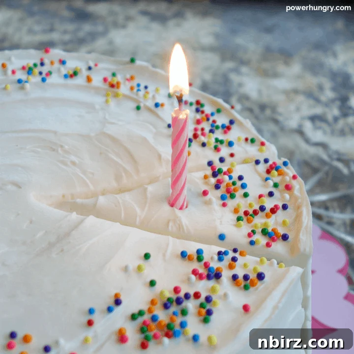 Vegan Vanilla Layer Cake: A Grain-Free Delight 12 Close-up of Vegan and Grain-Free Vanilla Layer Cake with a Birthday Candle