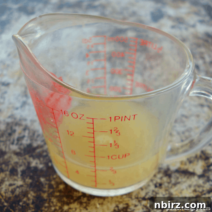 Vegan Vanilla Layer Cake: A Grain-Free Delight 6 Glass Measuring Cup Filled with Aquafaba