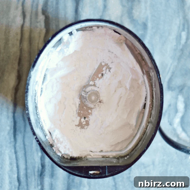 Silky Smooth Vegan Vanilla Buttercream Without Cornstarch 3 Overhead shot of a bowl filled with freshly made DIY powdered sugar, showing its fine, cornstarch-free texture.