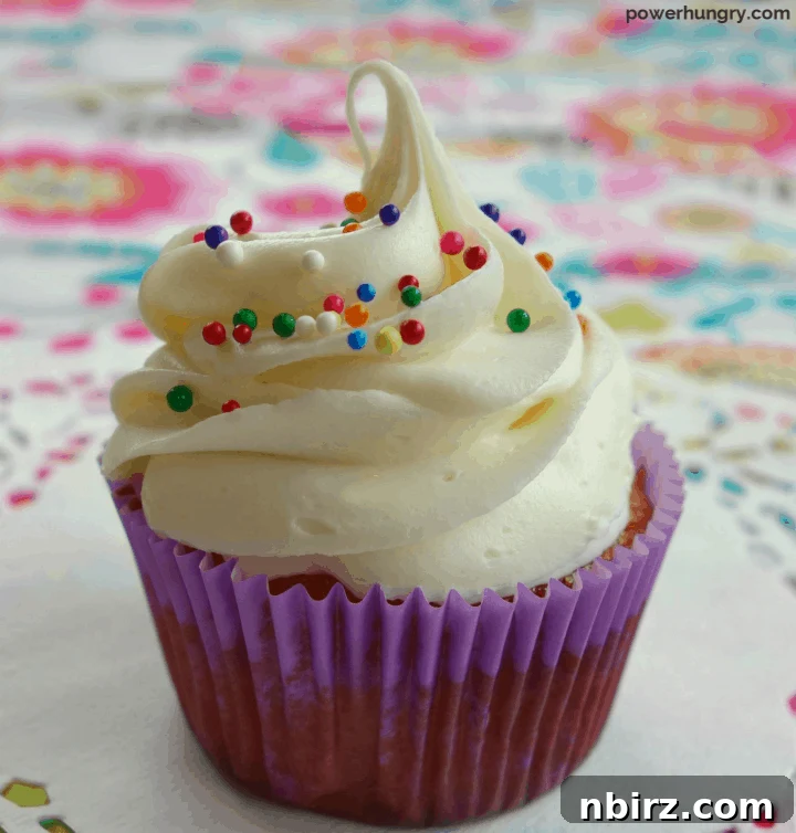 Silky Smooth Vegan Vanilla Buttercream Without Cornstarch 6 Close-up of a beautifully decorated cupcake, generously topped with swirled vegan vanilla buttercream frosting.