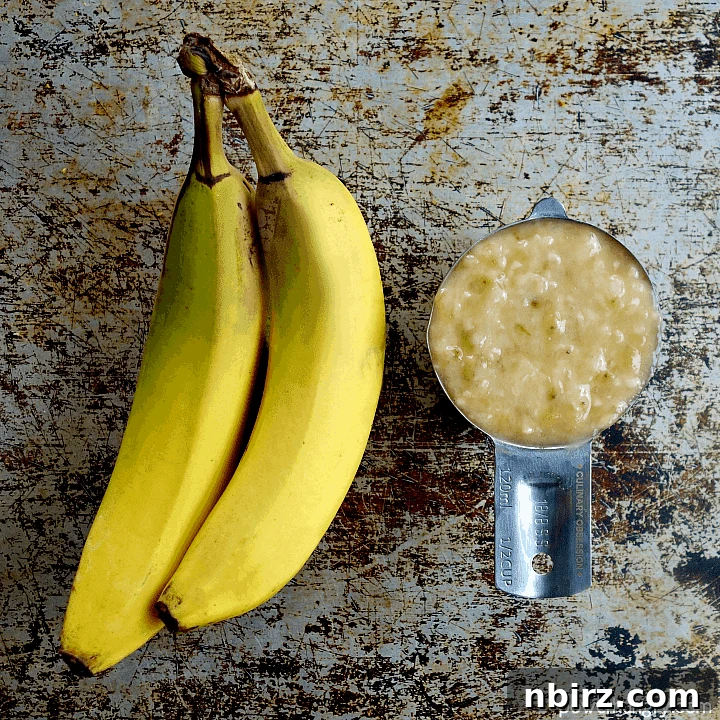 Under-ripe banana next to mashed banana in a measuring cup